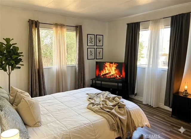 a bedroom with a bed and a flat screen tv