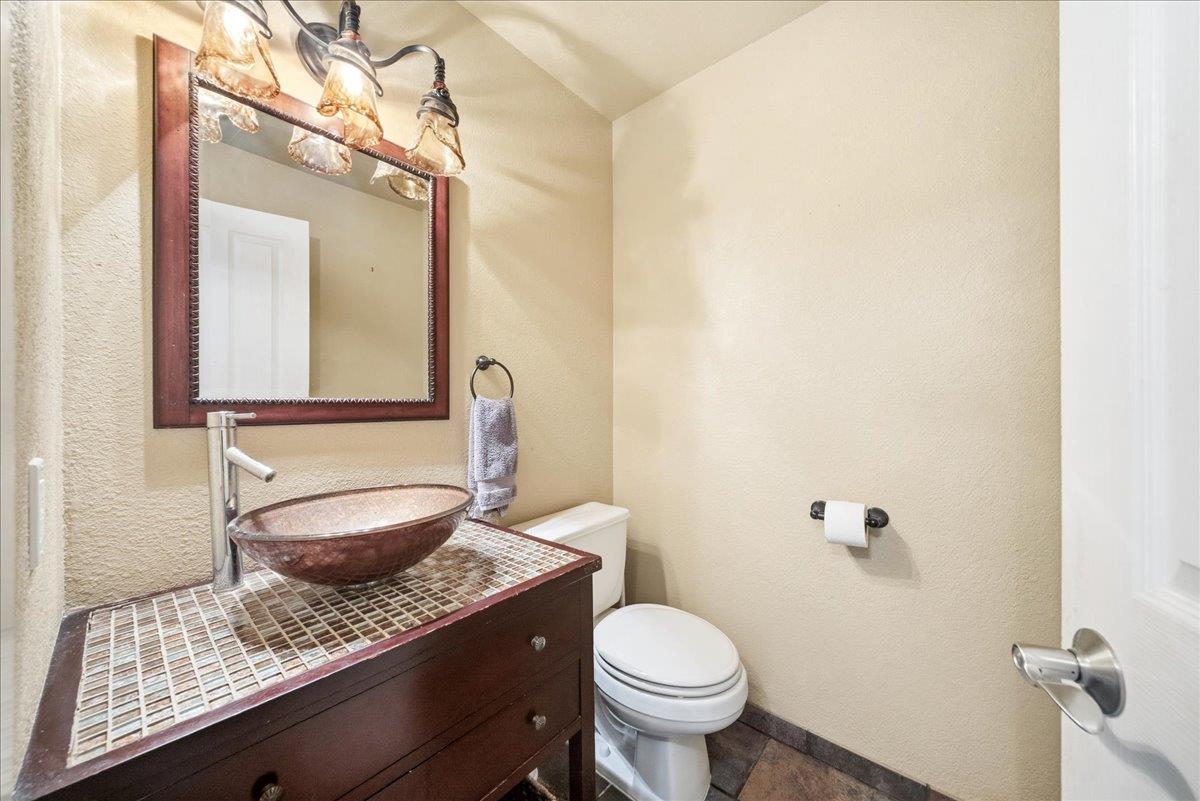 16035 Running Springs Road Grass Valley, CA 95949 - Photo 15 of 94 a bathroom with a granite countertop sink a toilet and a mirror