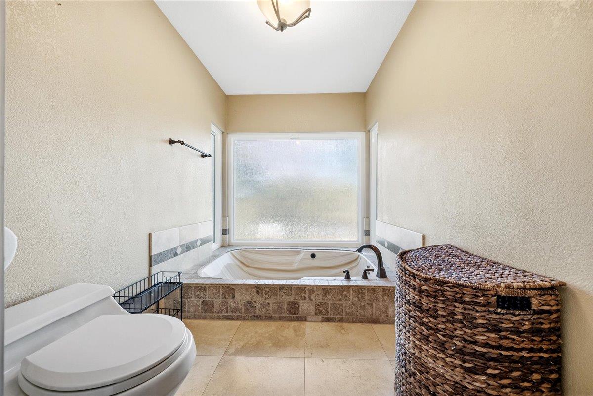 16035 Running Springs Road Grass Valley, CA 95949 - Photo 22 of 94 a bathroom with a granite countertop bathtub sink vanity mirror and toilet