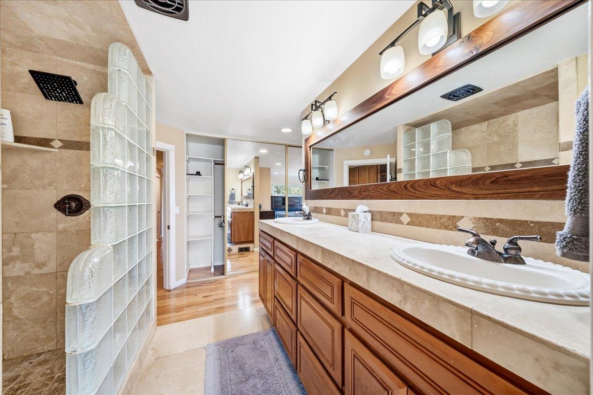 16035 Running Springs Road Grass Valley, CA 95949 - Photo 23 of 94 a spacious bathroom with a double vanity sink a mirror and shower