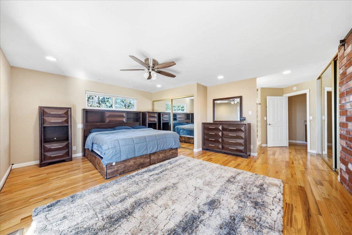 16035 Running Springs Road Grass Valley, CA 95949 - Photo 24 of 94 a bedroom with a large bed a flat tv screen and dresser