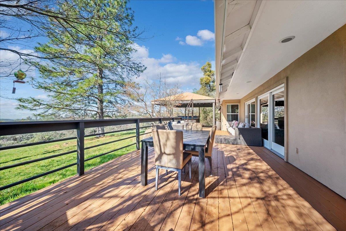 16035 Running Springs Road Grass Valley, CA 95949 - Photo 45 of 94 a view of a patio with table and chairs potted plants with wooden floor