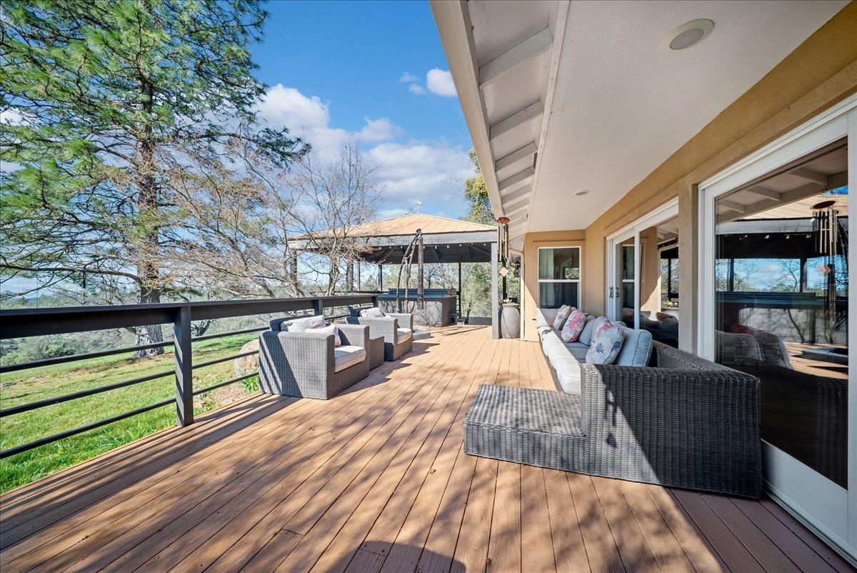16035 Running Springs Road Grass Valley, CA 95949 - Photo 46 of 94 a view of a patio with table and chairs barbeque with wooden floor and fence