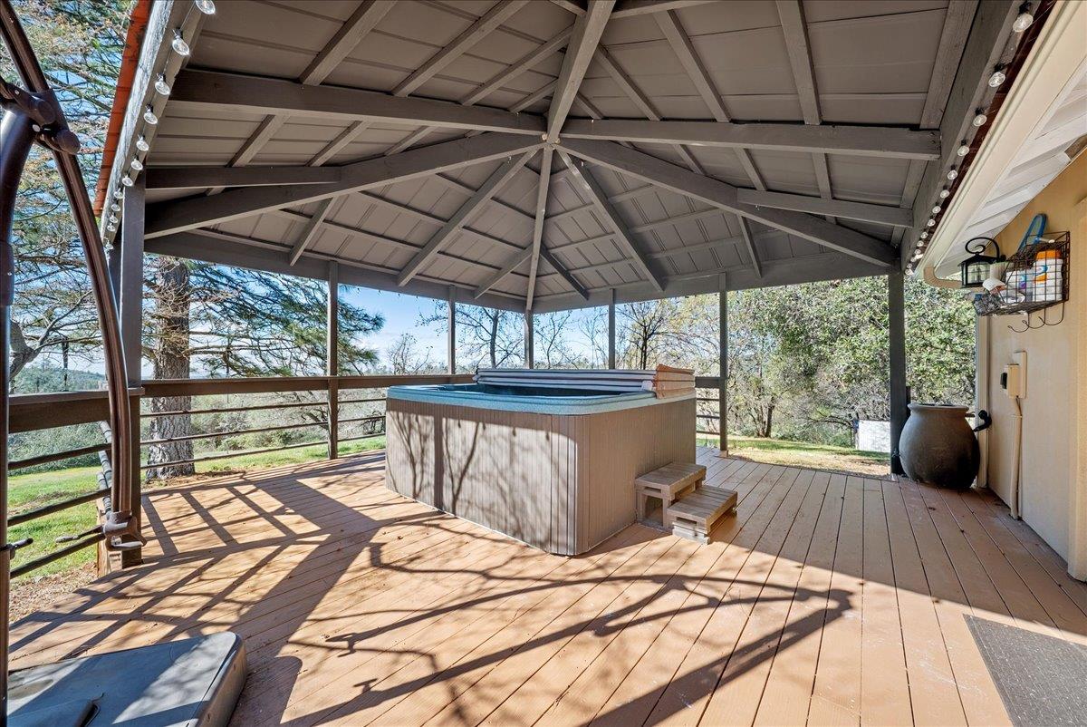 16035 Running Springs Road Grass Valley, CA 95949 - Photo 47 of 94 a view of a patio with table and chairs under an umbrella with a barbeque