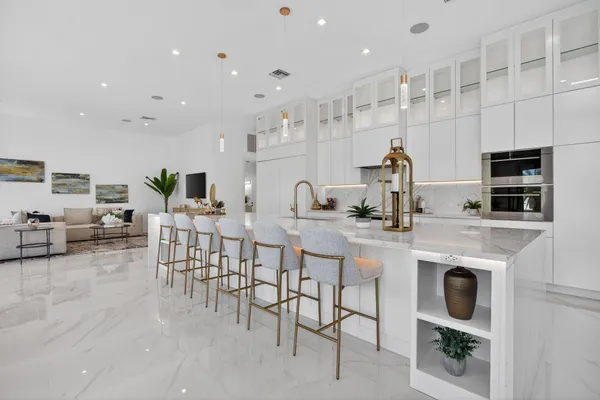 a living room with furniture and a floor to ceiling window