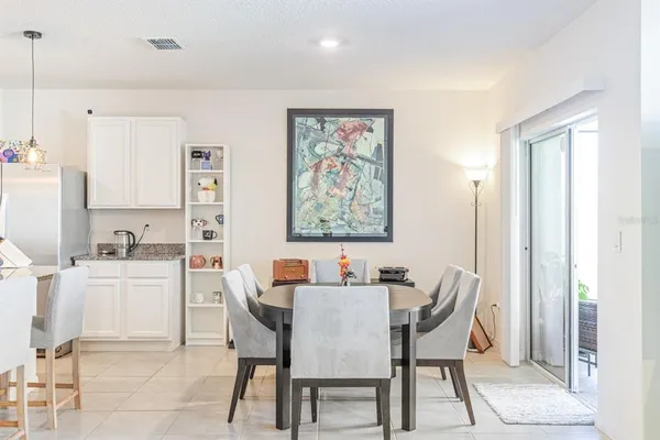 a dining room with furniture and window