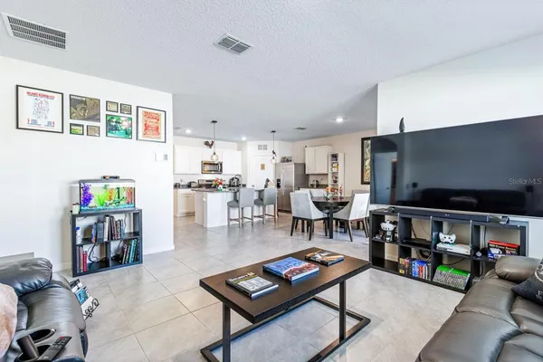 a living room with lots of furniture and a flat screen tv