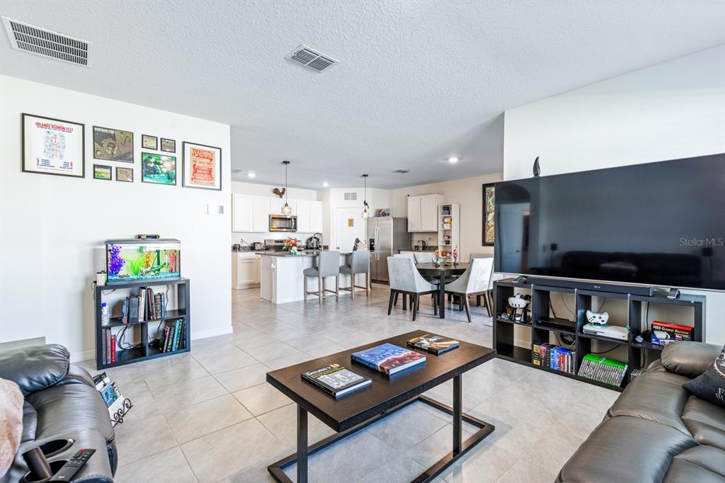 5381 Hickory Downs Way St. Cloud, FL 34771 - Photo 15 of 35 a living room with lots of furniture and a flat screen tv
