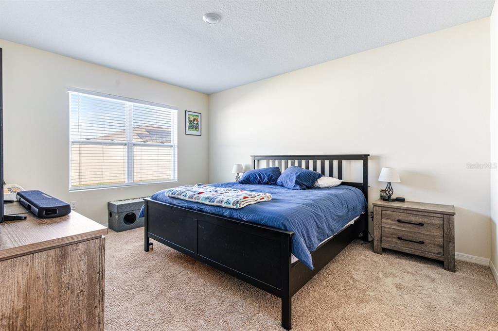 5381 Hickory Downs Way St. Cloud, FL 34771 - Photo 17 of 35 a bedroom with a bed and a window