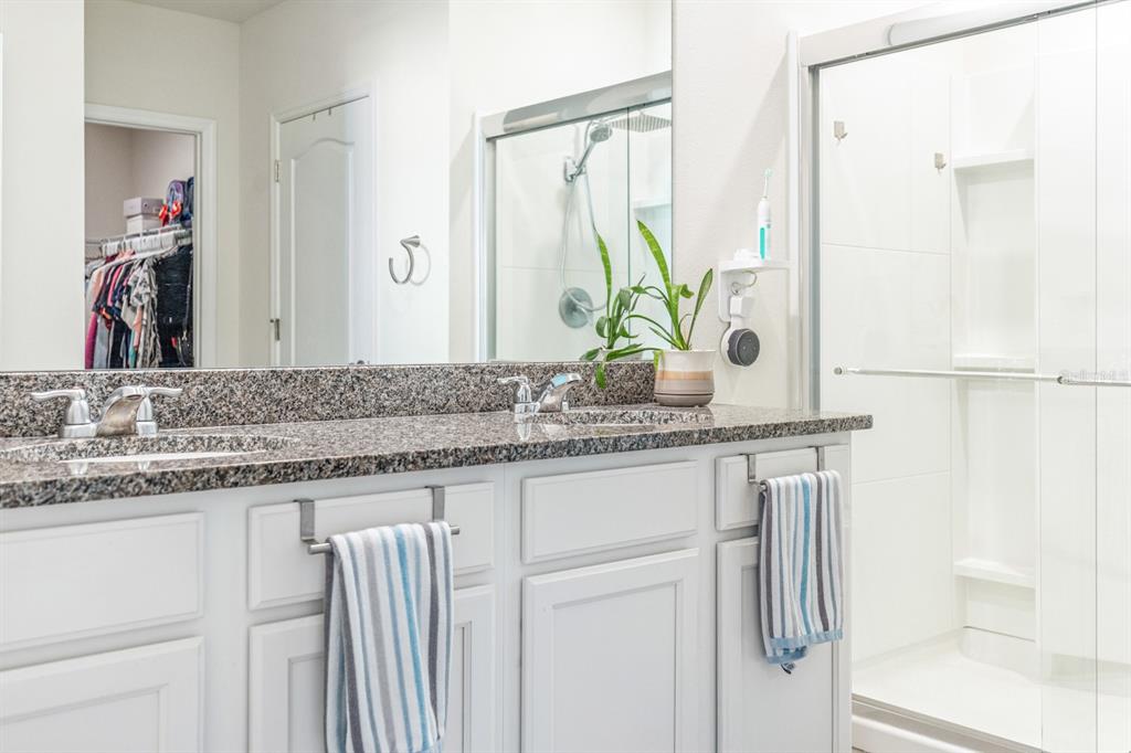5381 Hickory Downs Way St. Cloud, FL 34771 - Photo 20 of 35 a bathroom with a granite countertop sink and a mirror