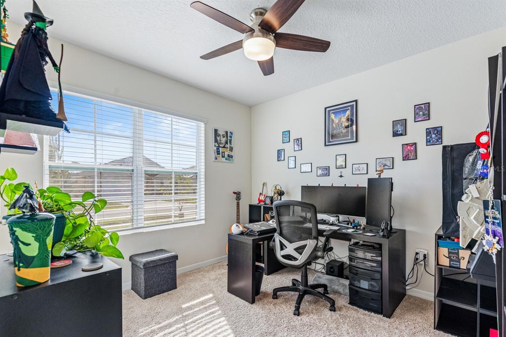 5381 Hickory Downs Way St. Cloud, FL 34771 - Photo 24 of 35 a work room with furniture and a potted plant