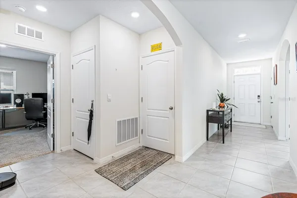 a view of a hallway view with couch and a living room