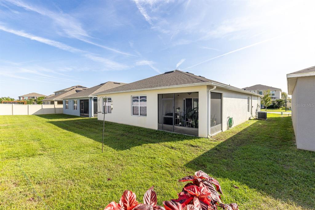 5381 Hickory Downs Way St. Cloud, FL 34771 - Photo 31 of 35 a view of a house with a yard