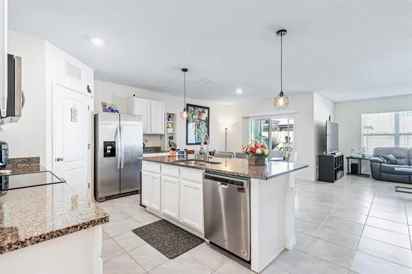 a kitchen with refrigerator and cabinets