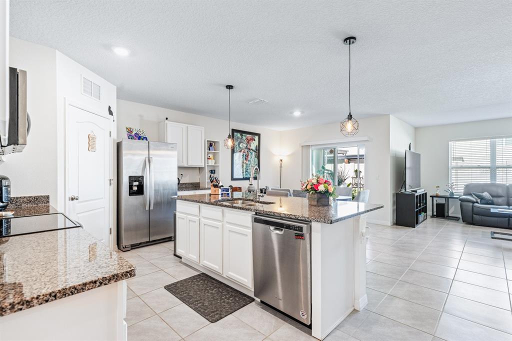 5381 Hickory Downs Way St. Cloud, FL 34771 - Photo 7 of 35 a kitchen with refrigerator and cabinets