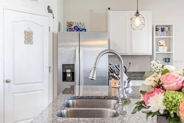 a bathroom with a granite countertop shower a sink and a mirror