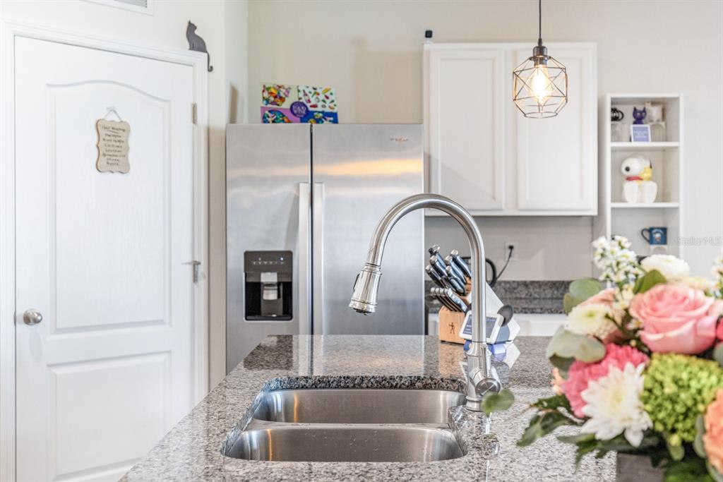 5381 Hickory Downs Way St. Cloud, FL 34771 - Photo 8 of 35 a bathroom with a granite countertop shower a sink and a mirror