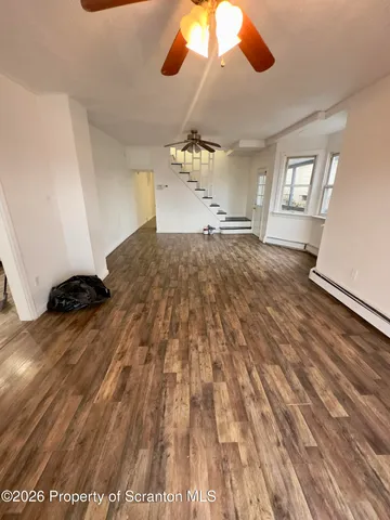 a kitchen with granite countertop a sink stove and cabinets
