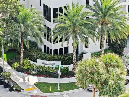 an aerial view of residential building and car parked