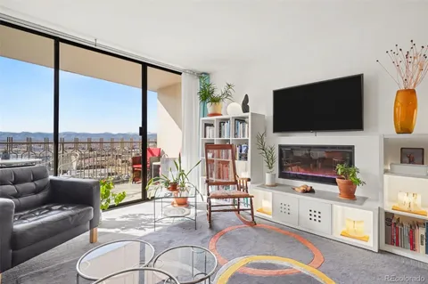 a living room with fireplace furniture and a flat screen tv
