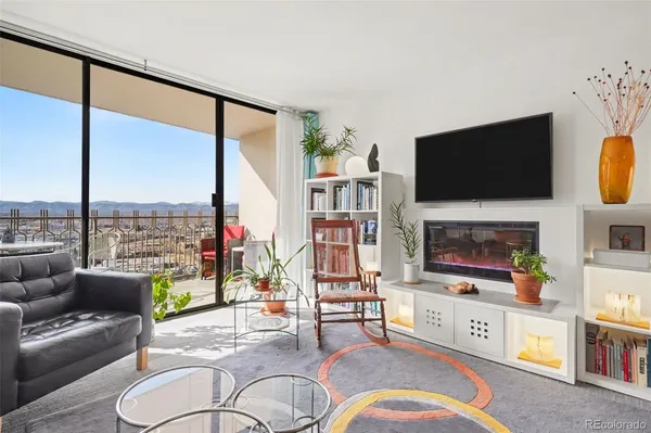 a living room with fireplace furniture and a flat screen tv