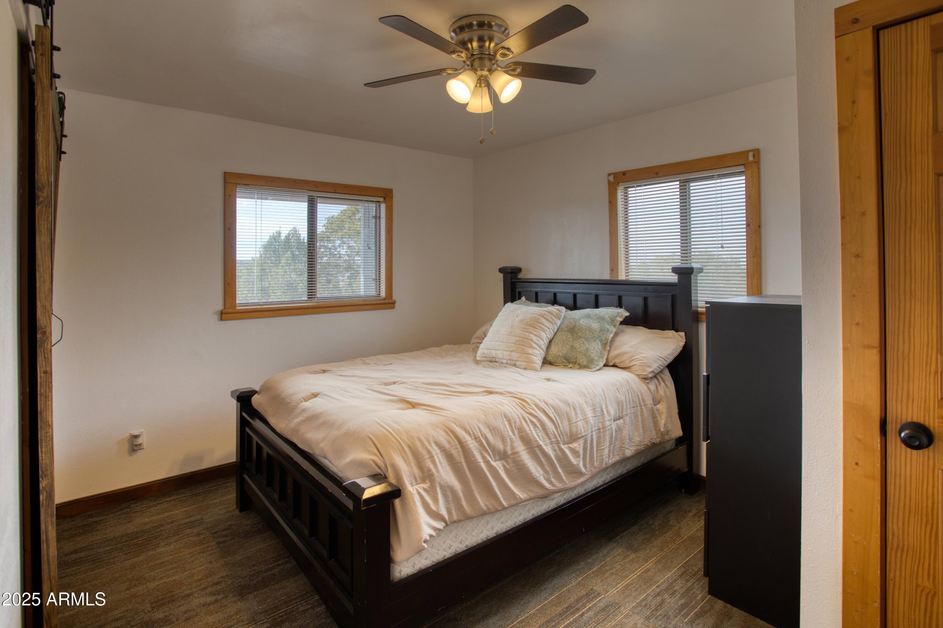 8286 Ridge Drive Show Low, AZ 85901 - Photo 10 of 21 a bedroom with a bed and window