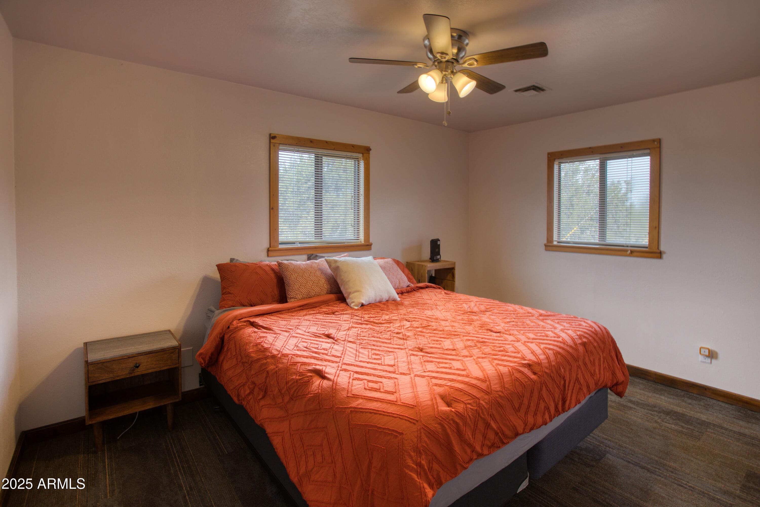 8286 Ridge Drive Show Low, AZ 85901 - Photo 12 of 21 a bed sitting in a bedroom next to a window