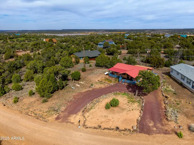 an aerial view of a house with a yard and sitting area