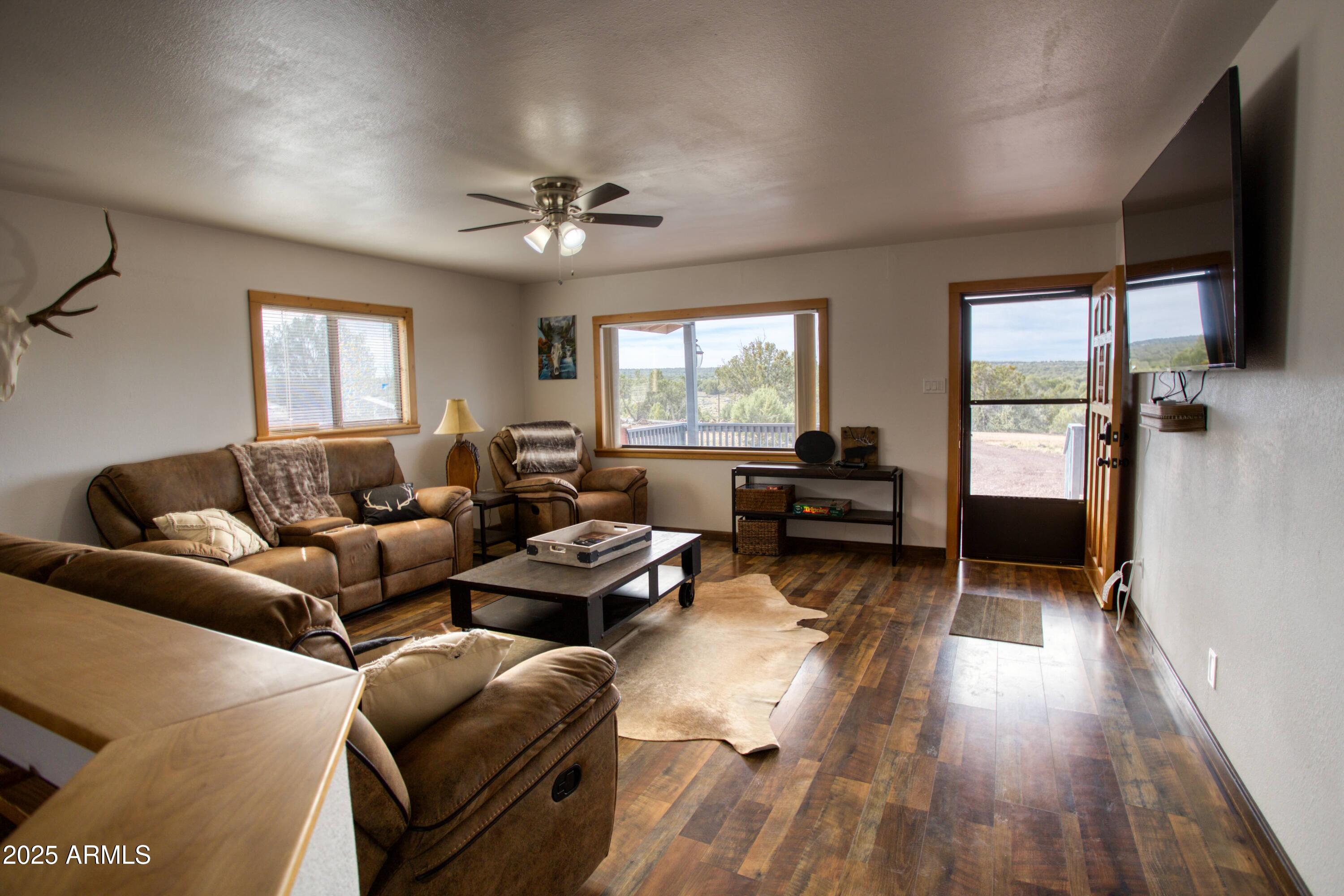 8286 Ridge Drive Show Low, AZ 85901 - Photo 5 of 21 a living room with furniture two window and a flat screen tv