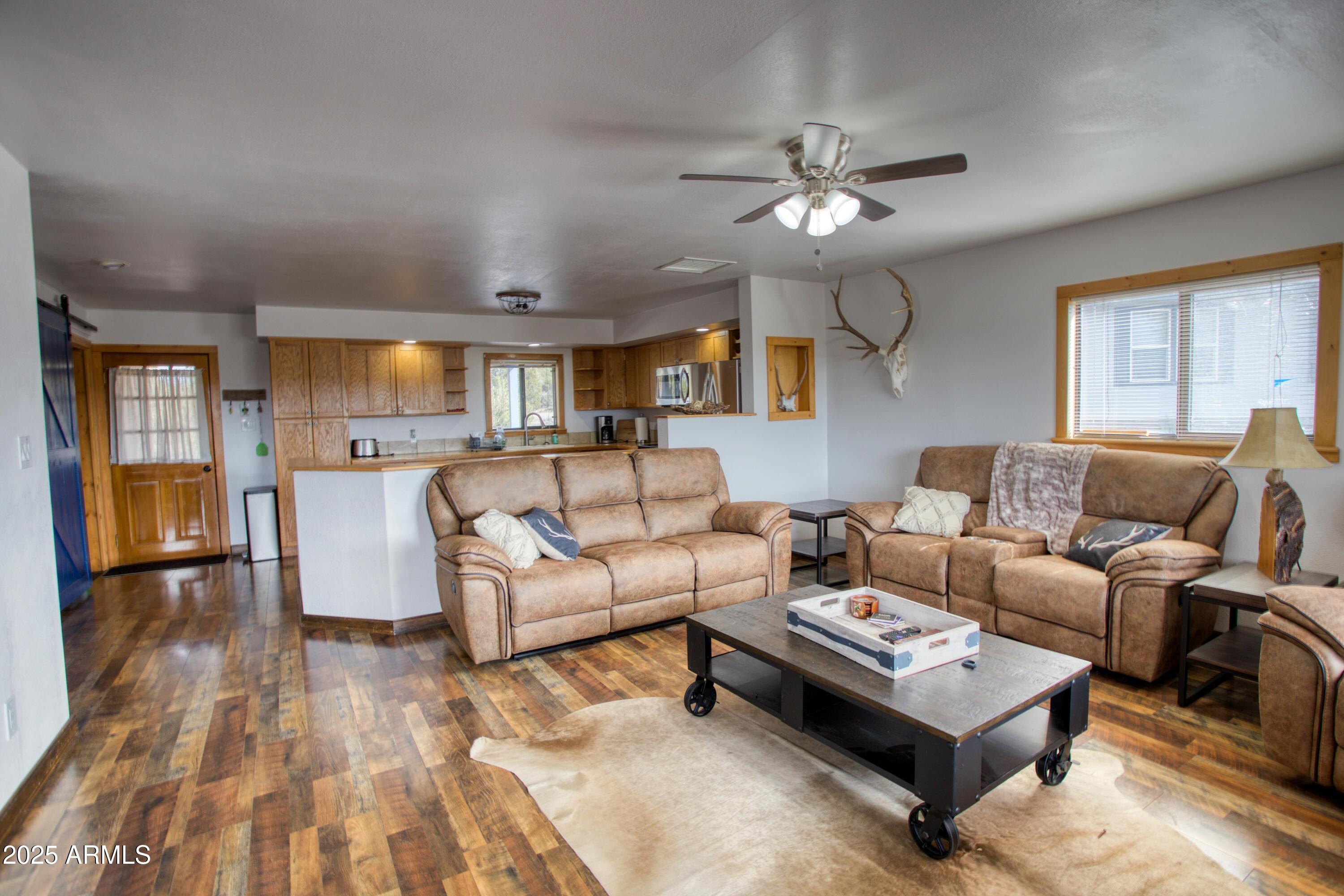 8286 Ridge Drive Show Low, AZ 85901 - Photo 21 of 21 a living room with furniture and a chandelier