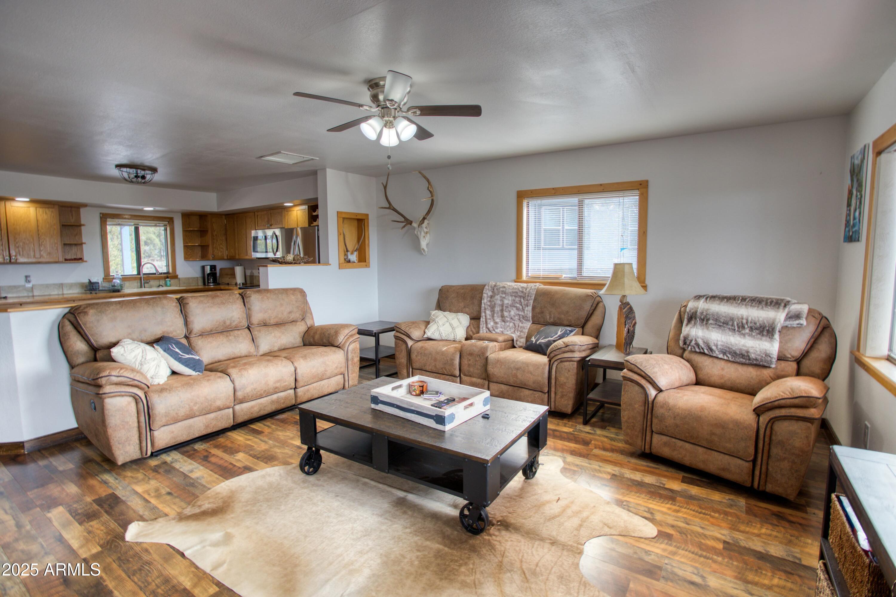8286 Ridge Drive Show Low, AZ 85901 - Photo 6 of 21 a living room with furniture and a chandelier