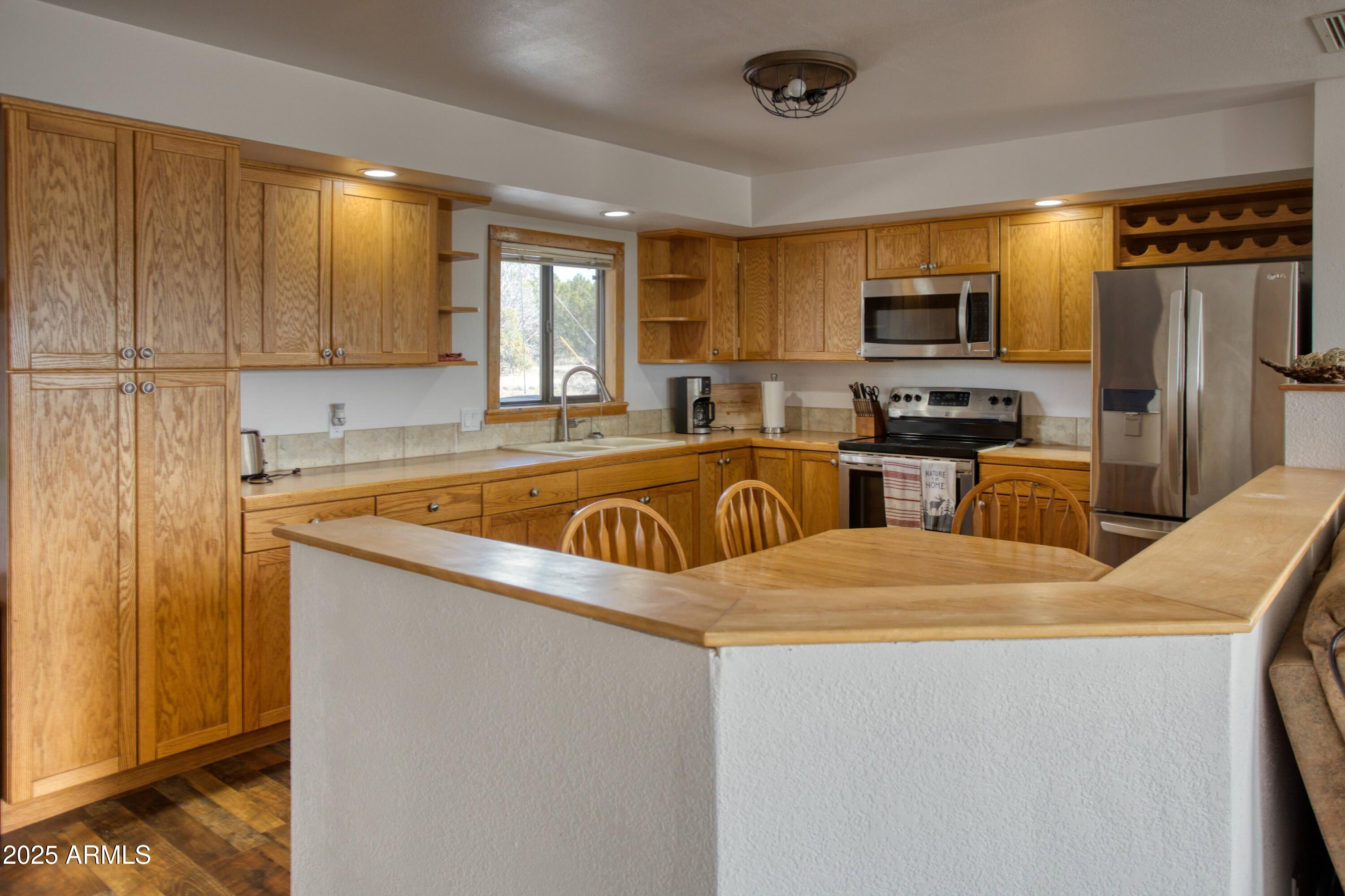 8286 Ridge Drive Show Low, AZ 85901 - Photo 8 of 21 a kitchen that has a sink and a refrigerator