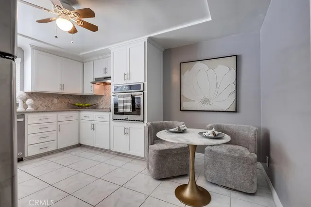 a kitchen with stainless steel appliances granite countertop a sink a stove and a refrigerator