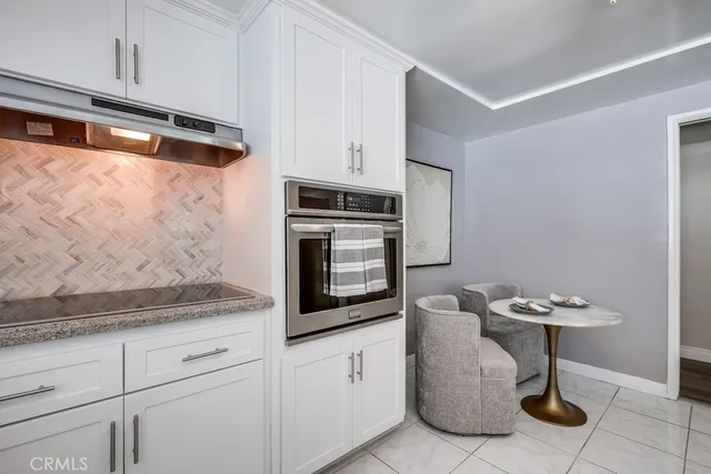 a kitchen with stainless steel appliances white cabinets and a granite counter tops