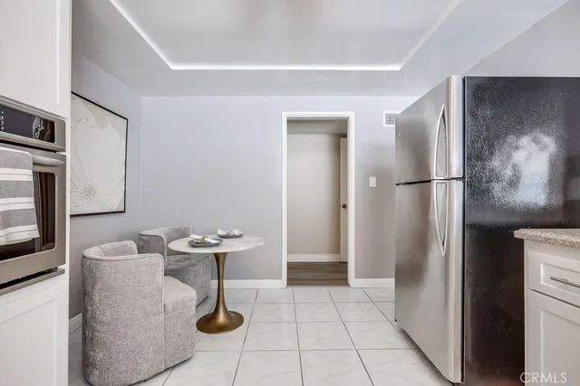 a kitchen with stainless steel appliances kitchen island granite countertop a refrigerator and a stove