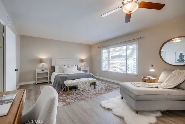 a living room with furniture and a large mirror