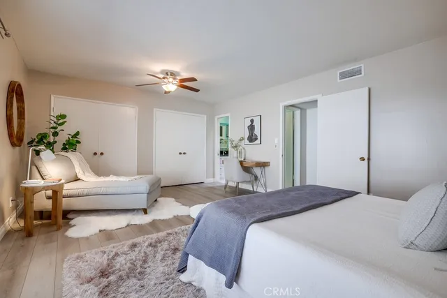 a bedroom with a bed couch and window