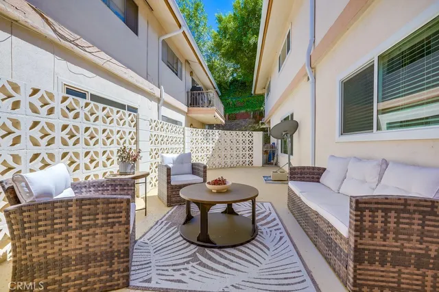 a balcony with furniture and a potted plant