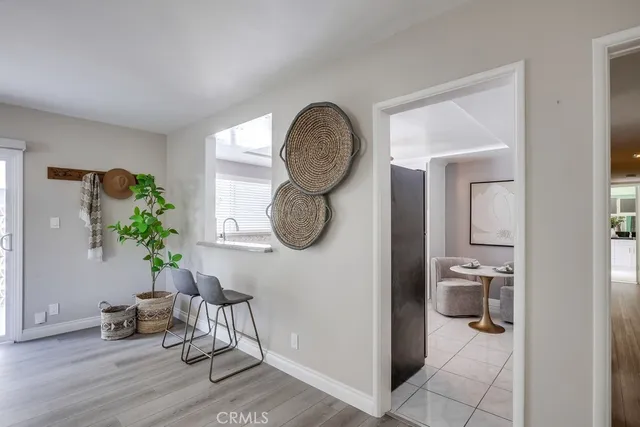 a living room with furniture a mirror and white walls