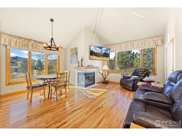 a living room with furniture a fireplace and wooden floor