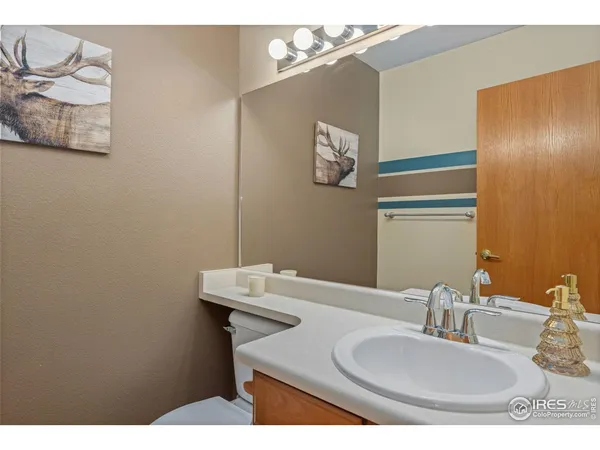 a bathroom with a sink a mirror a vanity and a shower