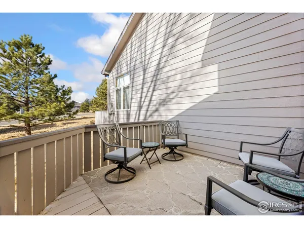 a view of balcony with wooden floor and seating space