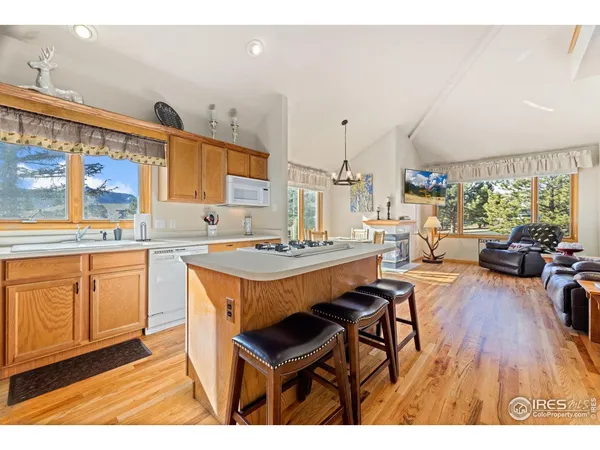 a living room with stainless steel appliances kitchen island granite countertop furniture and a kitchen view