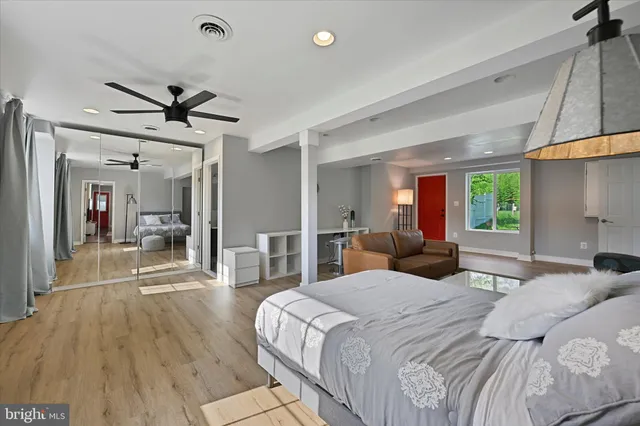 a bedroom with a bed and wooden floor