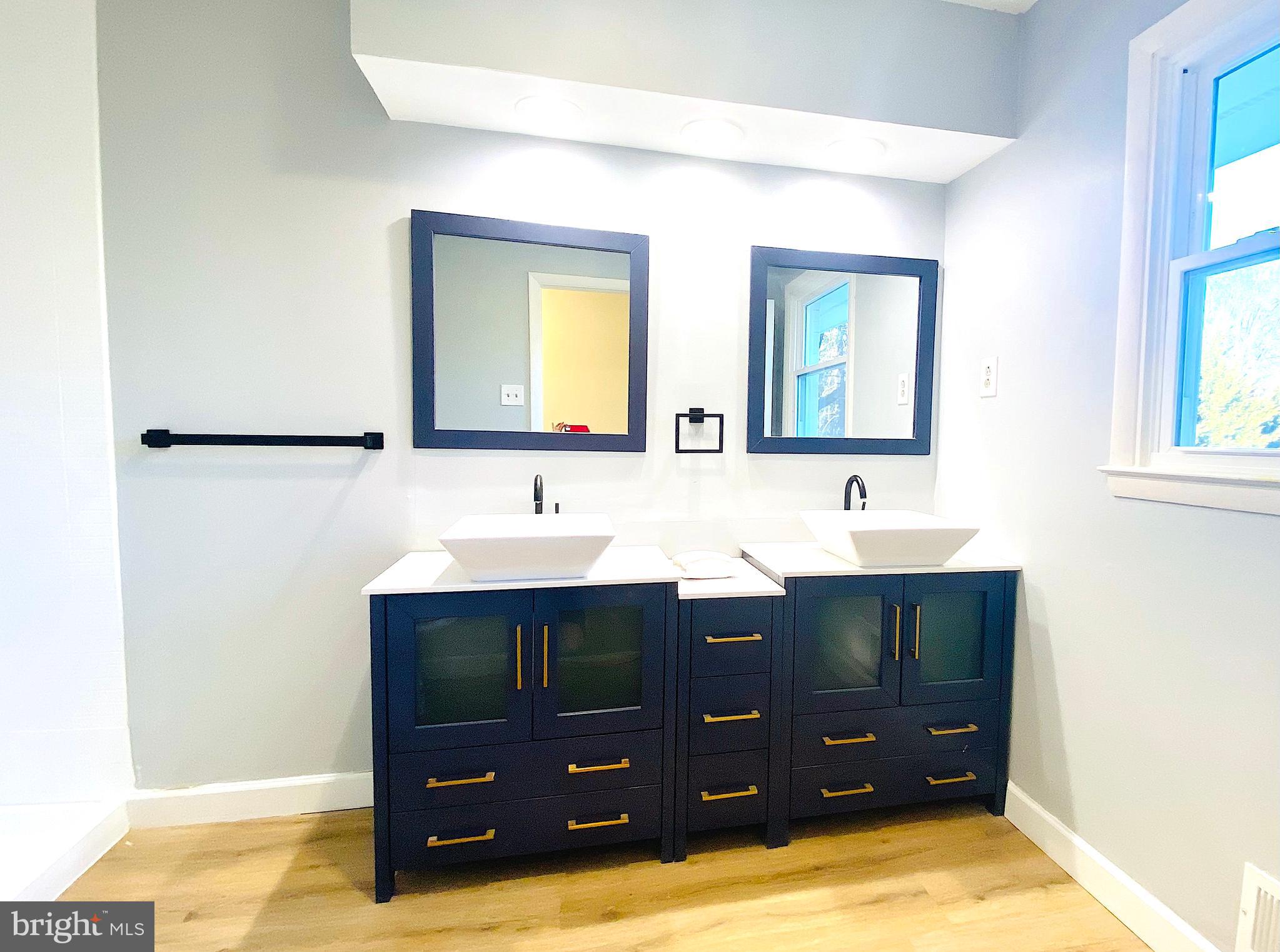 10533 Stevenson Road Stevenson, MD 21153 - Photo 29 of 45 a bathroom with a sink and mirror