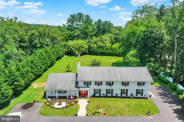 an aerial view of a house with swimming pool and big yard
