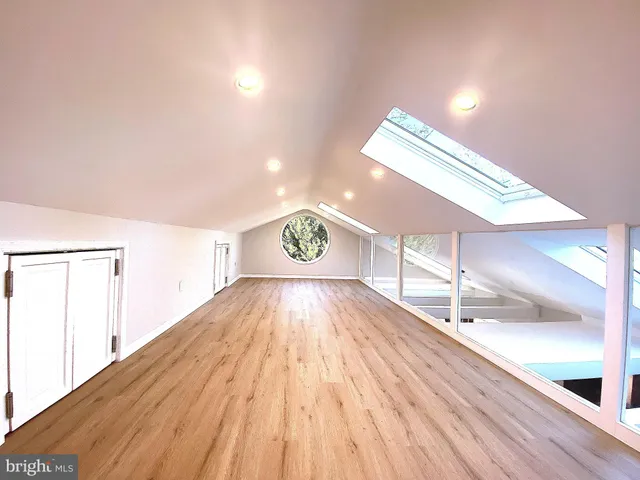 a view of an empty room and wooden floor
