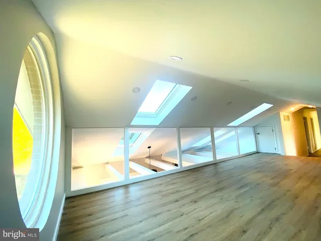 a view of a room with wooden floor