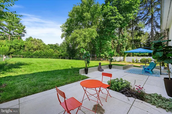 a view of a chairs and tables in the back yard of the house