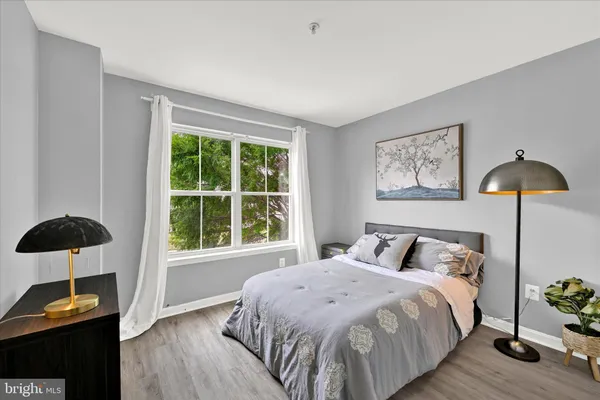 a bedroom with a bed a lamp and a window